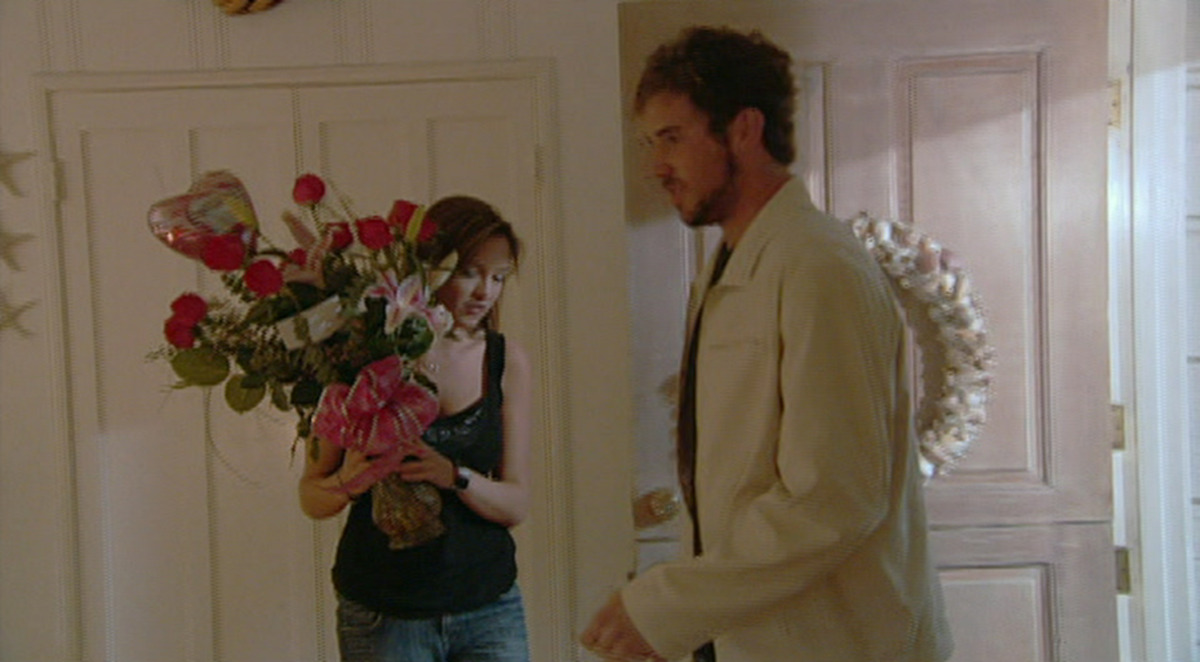 A woman accepting a rose bouquet. 