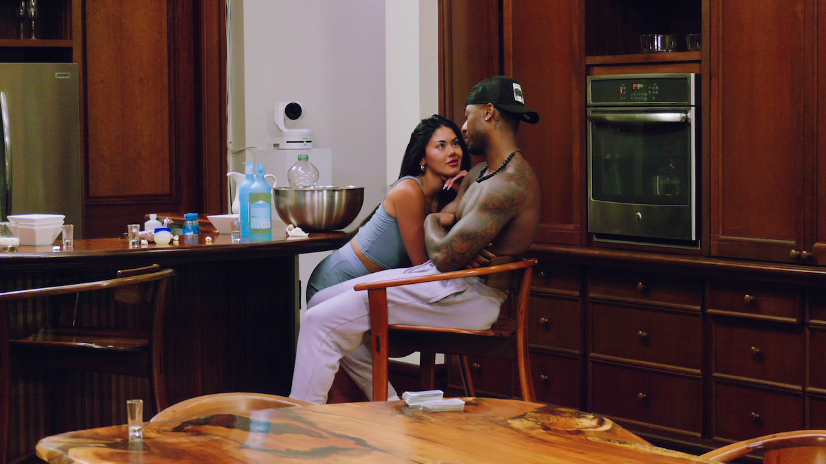 Alex Zamora leans on Brion Whitley in the kitchen.