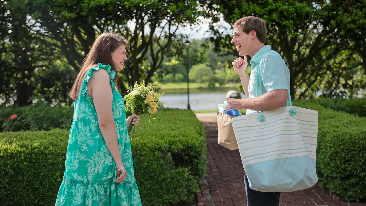 Tanner carrying a bag over his shoulder while speaking to someone.