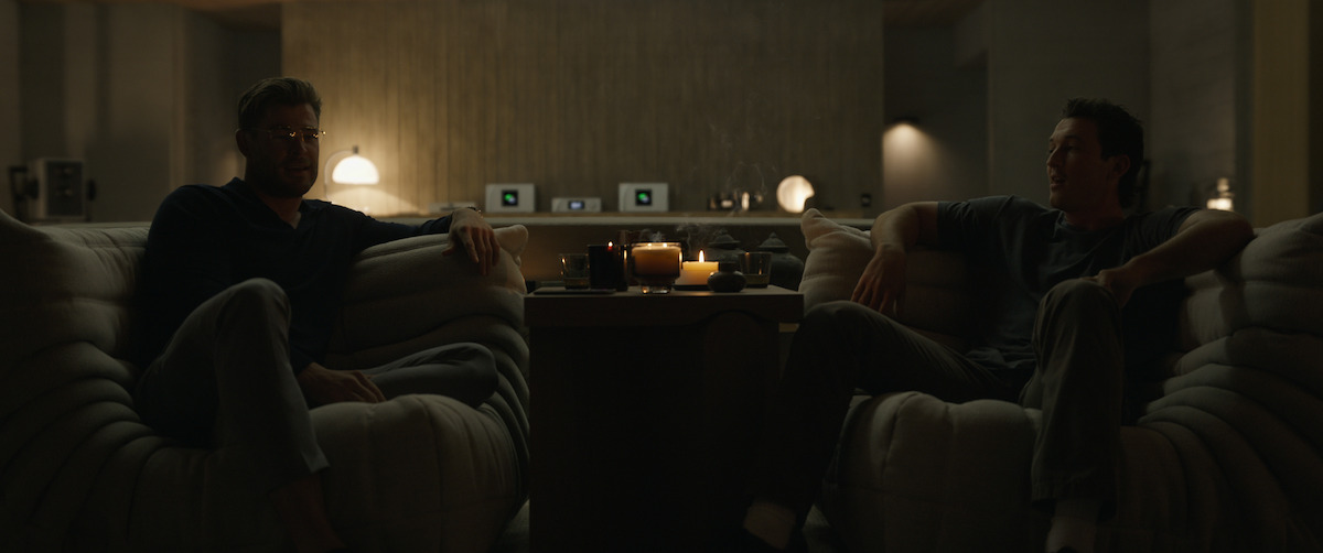 Jeff kicks back in the marshmallowy Togo chairs in Abnesti’s living space - The Beauty of Brutalism: the Design References in ‘Spiderhead’ Revealed