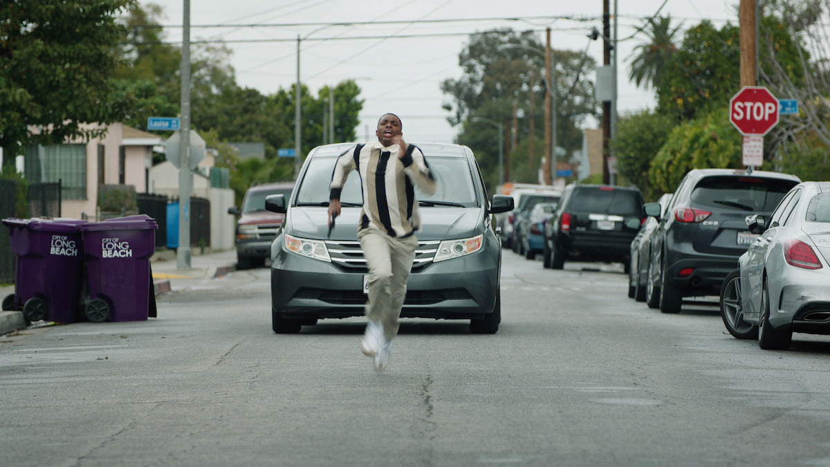 Vince Staples as Vince Staples runs as a car chases him down in Season 1 of ‘The Vince Staples Show’