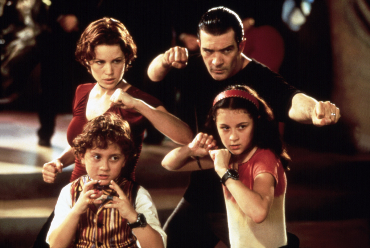 Carla Gugino as Ingrid Cortez, Daryl Sabara as Juni Cortez, Antonio Banderas as Gregorio Cortez, and Alexa Vega as Carmen Cortez strike an action pose together in ‘Spy Kids.’