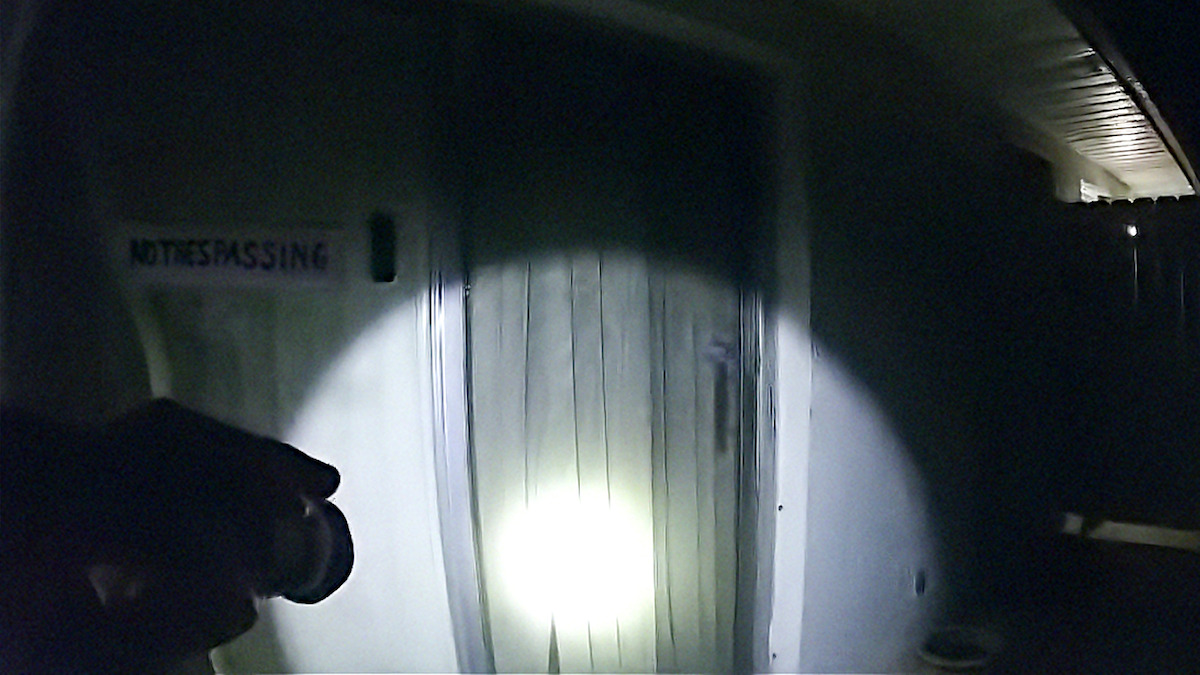 Body cam footage of flashlight on a door