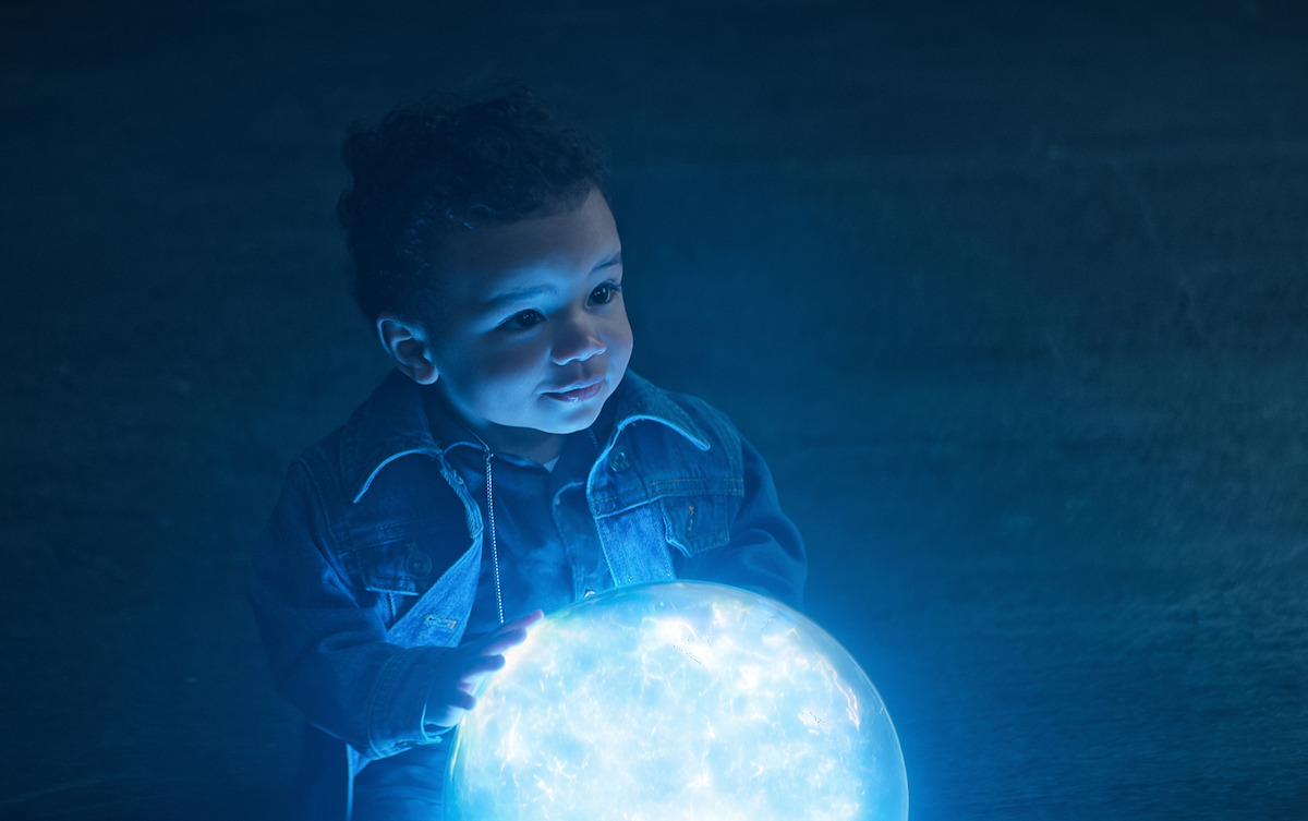 A baby holds a glowing orb in ‘The Sandman’ Season 2.