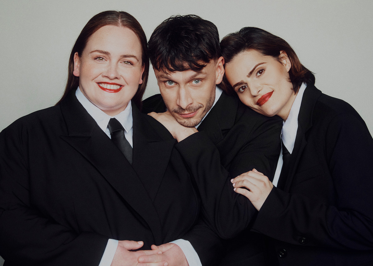 Jessica Gunning, Richard Gadd, and Nava Mau pose in suits against a light grey background.