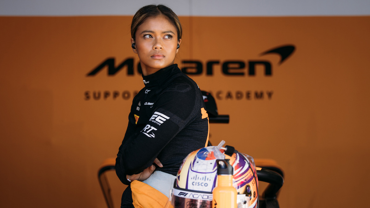 Bianca Bustamante sits on her car.