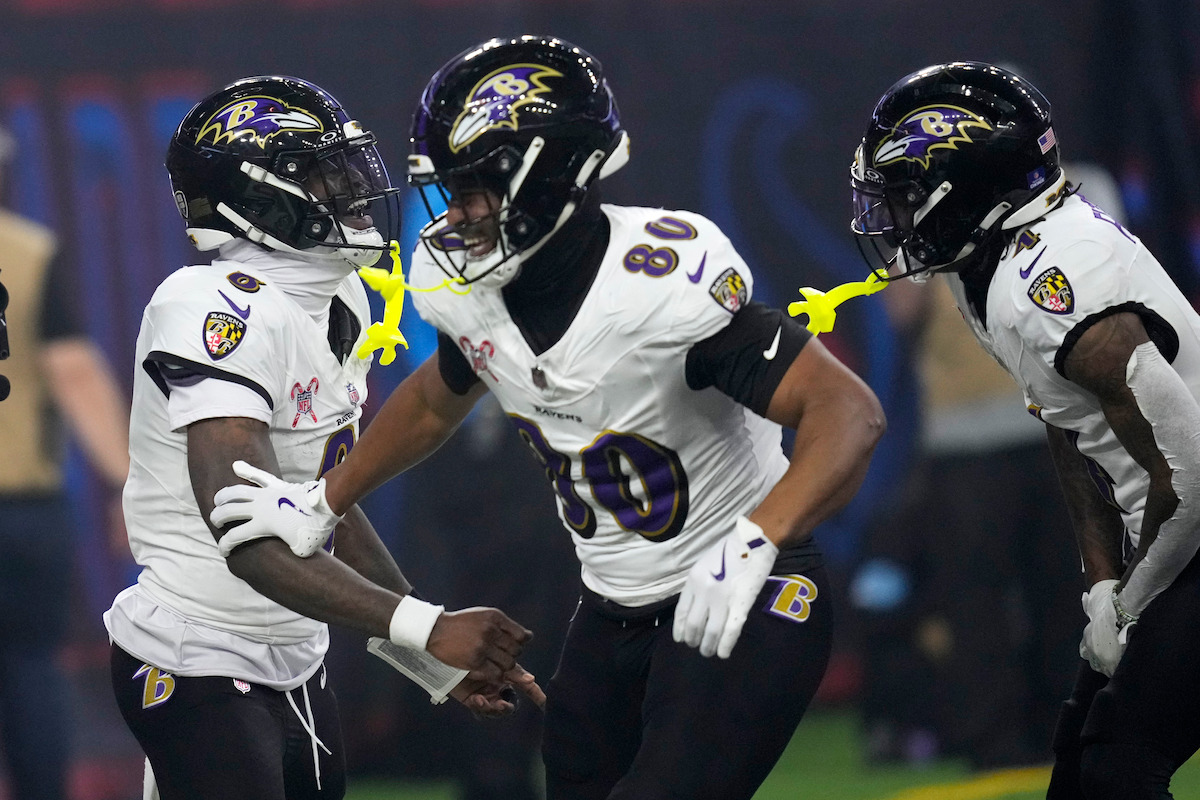 Baltimore Ravens quarterback Lamar Jackson, left, celebrates with teammates after a 48-yard touchdown run during the second half of an NFL football game against the Houston Texans, Wednesday, Dec. 25, 2024, in Houston.