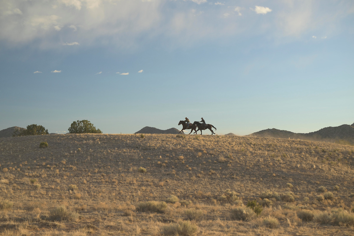 Two riders on horseback on a plains