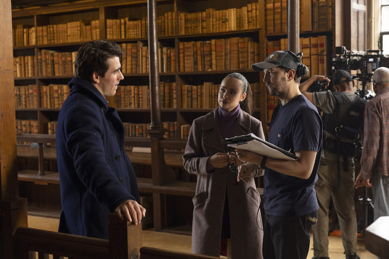 Corey Mylchreest, Iain Morris, and Sofia Carson talking on the set of 'My Oxford Year'.