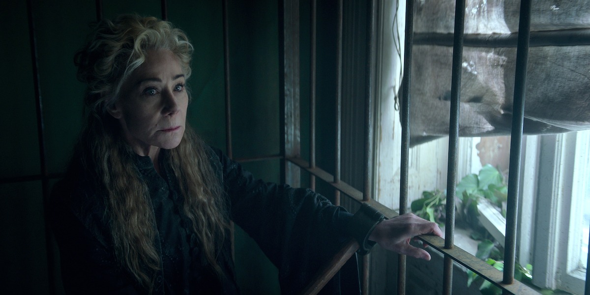 Zoë Wanamaker next to a window as Baghra