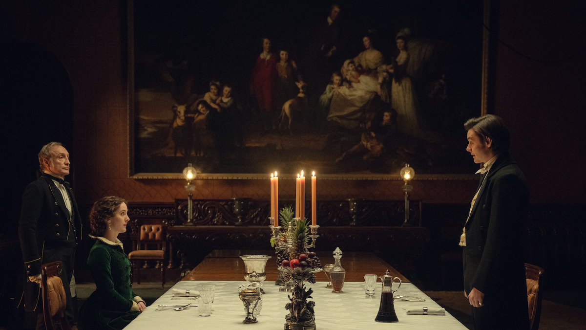 Ann Skelly as Adelaide Guinness and Louis Partridge as Edward Guinness talk at a dining room table in ‘House of Guinness’ Season 1.