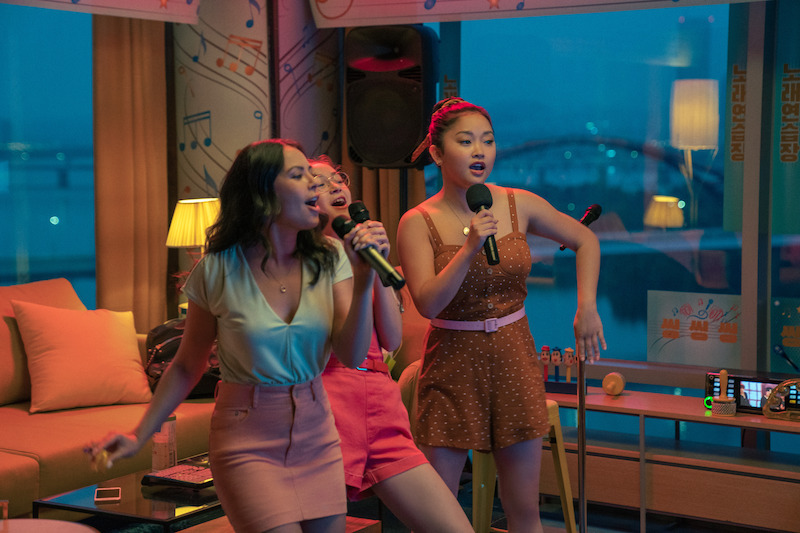 Anna Cathcart as Kitty, Lana Condor as Lara Jean, and Janel Parrish as Margot singing karaoke.