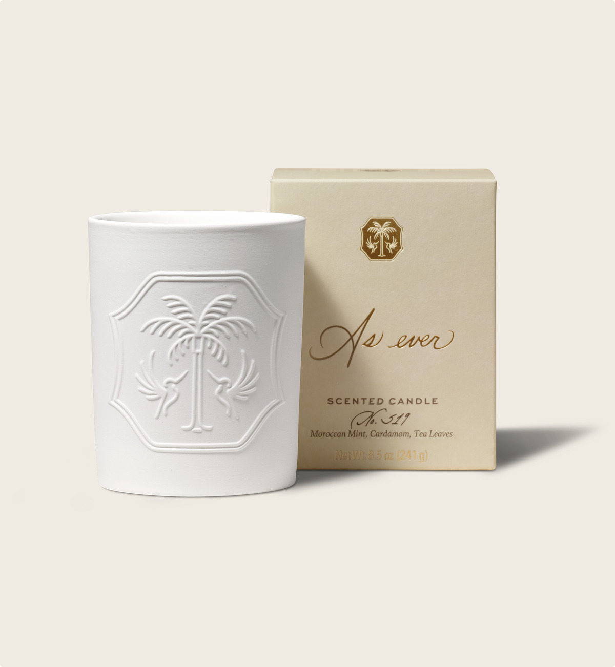 White decorative candle with embossed palm-tree design next to a cream-colored box labeled "As ever," set against a neutral background, creating an elegant and calm mood.