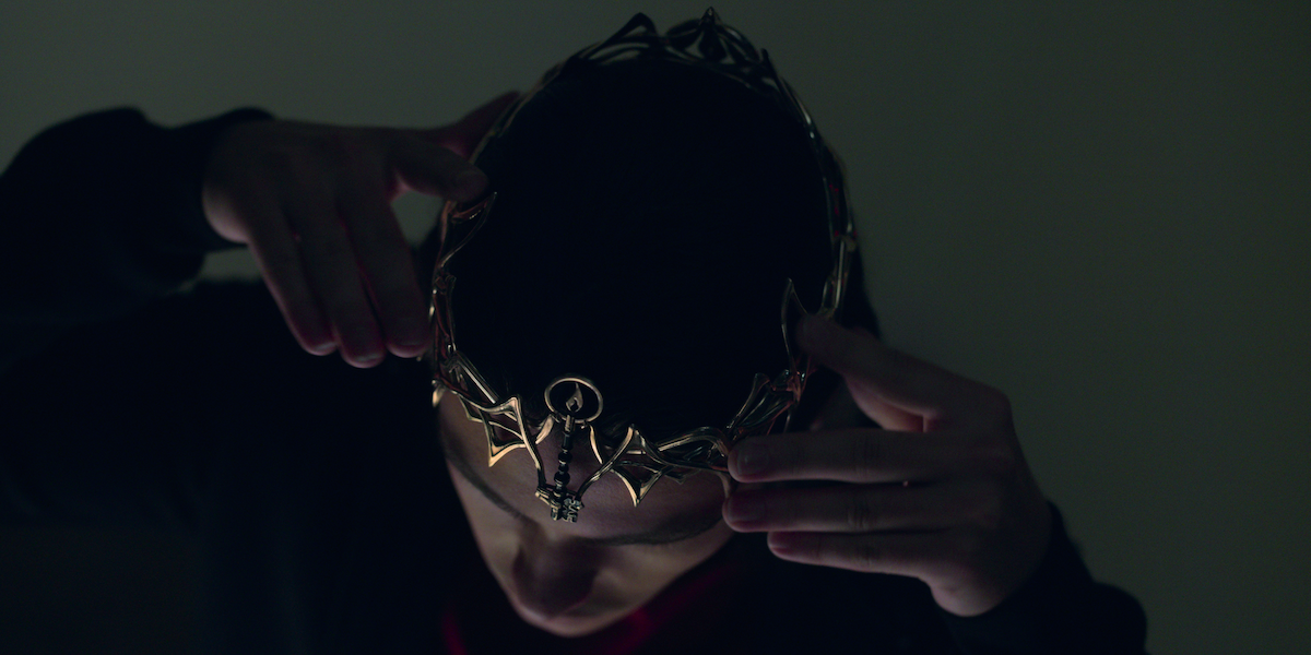  Felix Mallard as Lucas Caravaggio dons a crown in 'Locke & Key.' 