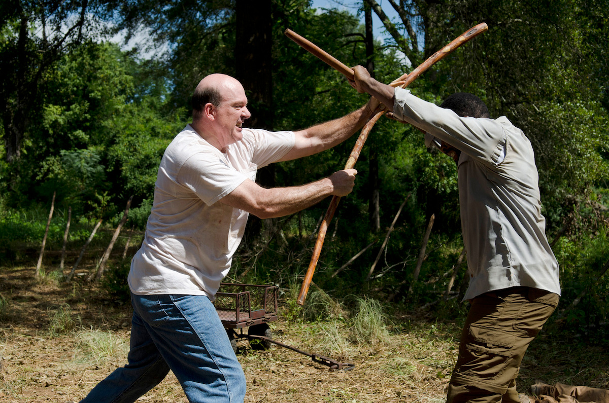 Rick fights with a bostaff against an enemy. 