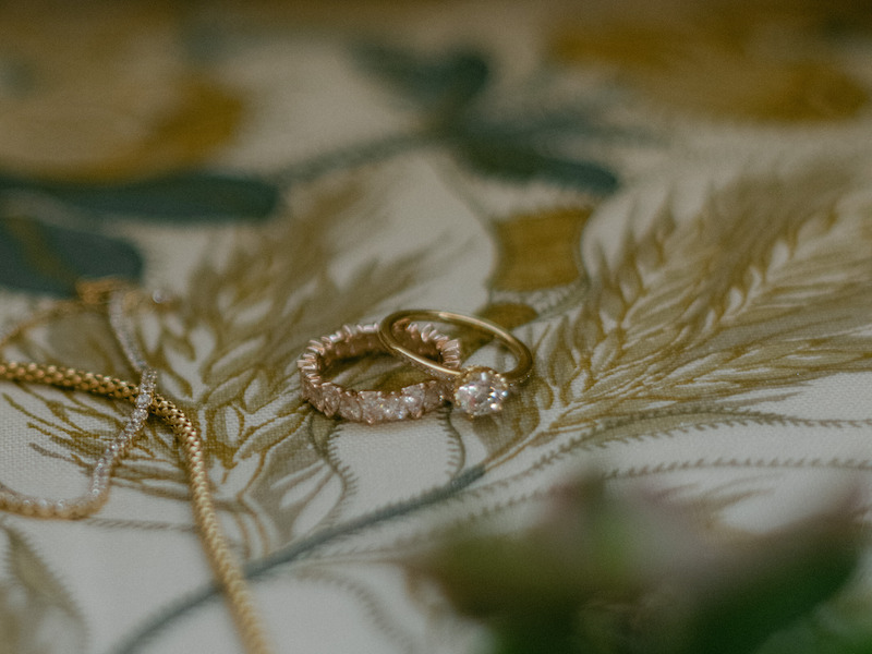 Two rings sit on a table in 'The Event of the Season: A Bridgerton Wedding'