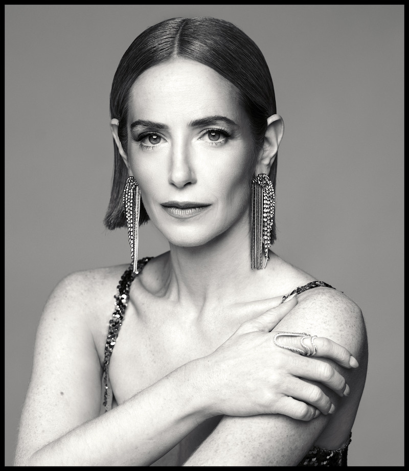 Jaime Ray Newman poses with her hand on her shoulder.