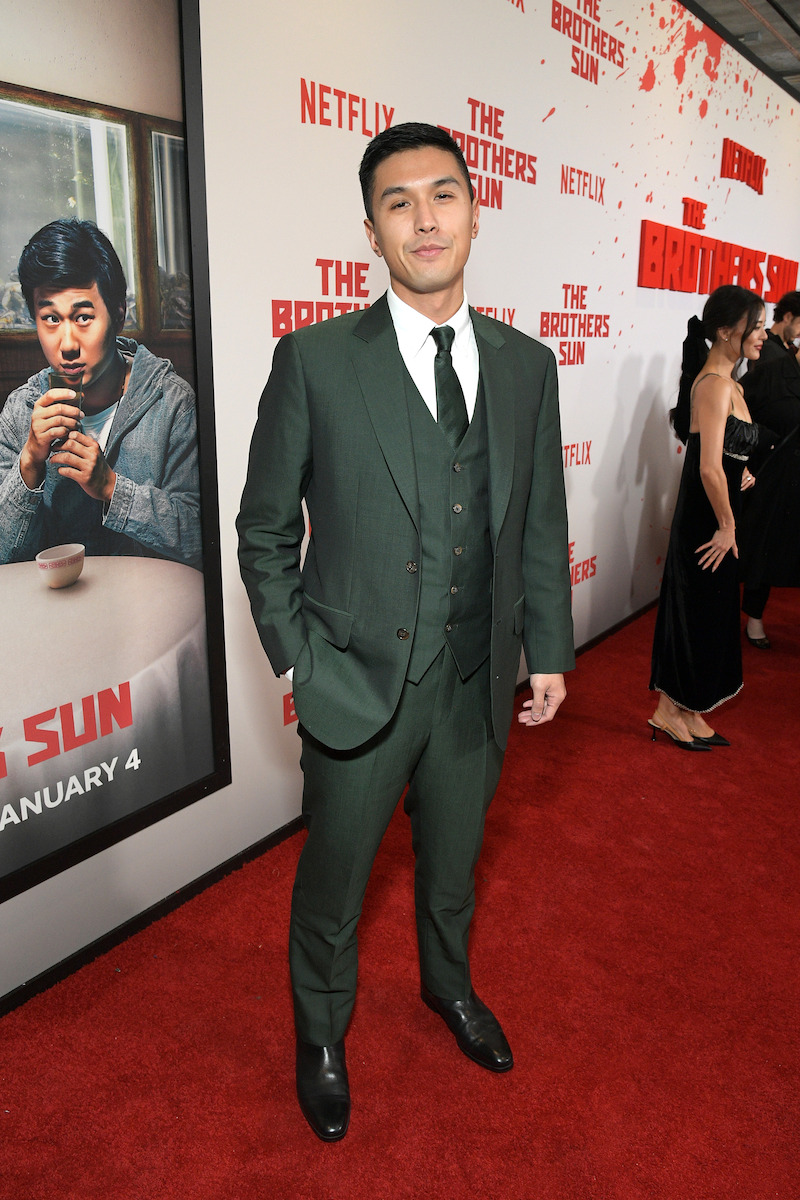 Byron Wu attends Netflix's 'The Brothers Sun' Los Angeles Premiere at Netflix Tudum Theater wearing a green suit