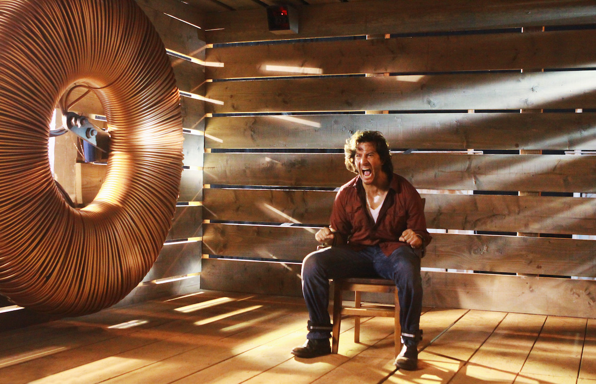 Henry Ian Cusick screams while tied to a chair.