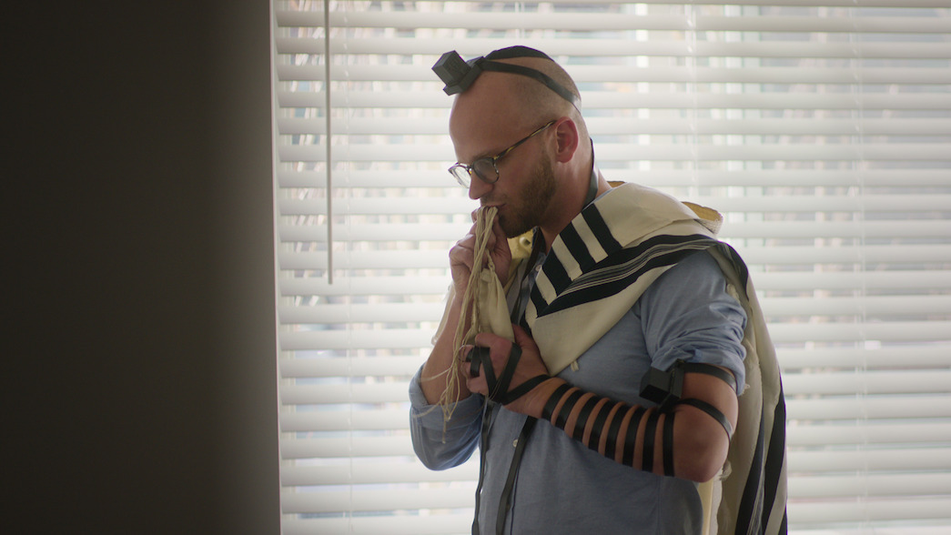 Noah Dreyfuss prays in his apartment. 