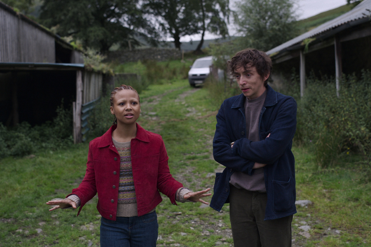 Myha’la Herrold as Pia and Samuel Blenkin as Davis speak together outside in Season 6 of ‘Black Mirror.’