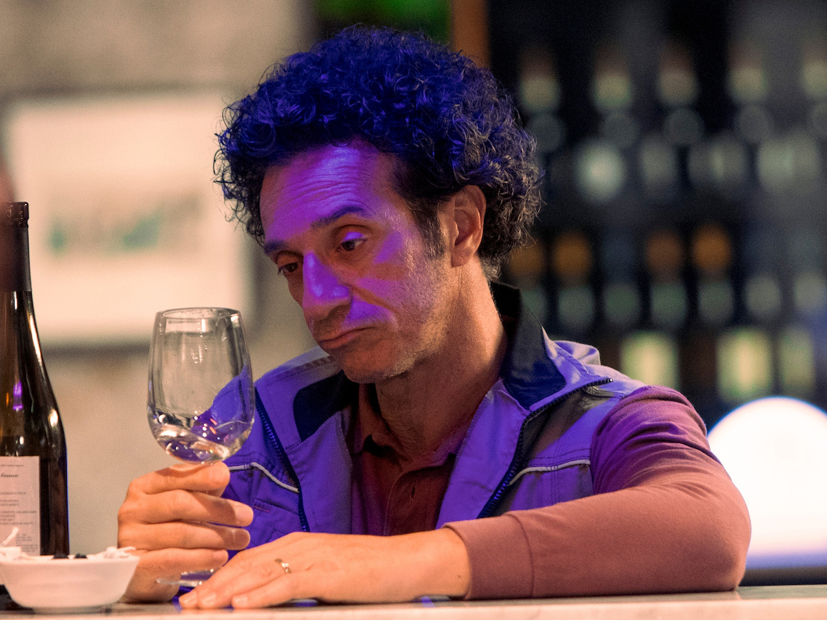An image of Salvo contemplating his wine