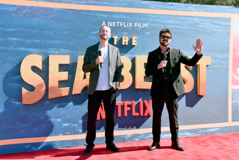 The Sea Beast director Chris Williams (left) and star Karl Urban (right) greet fans at The Sea Beast premiere.