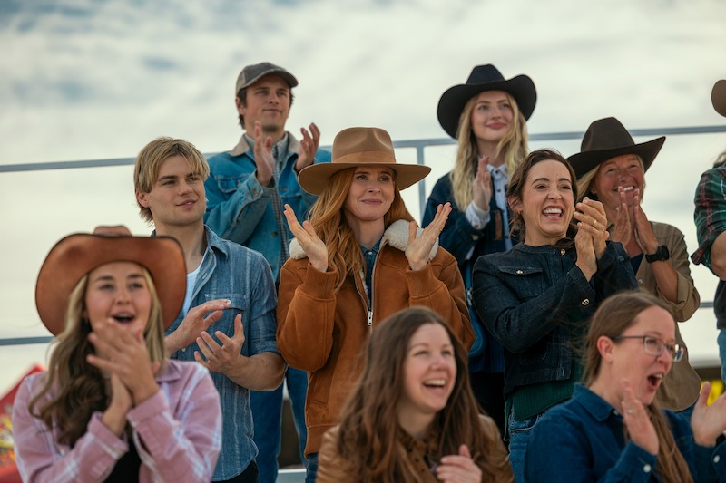 LaLonde as Cole and Rafferty as Katherine cheer at an outdoor event in 'My Life with the Walter Boys' Season 2