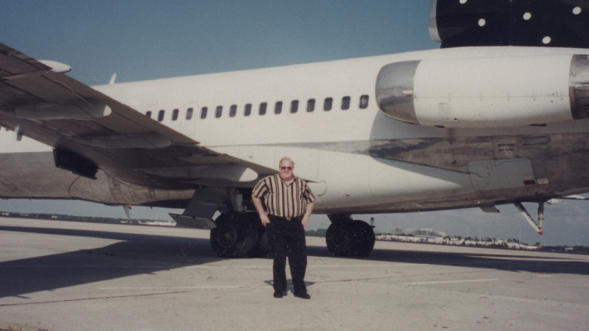 Lou Pearlman stands in front of a jet.