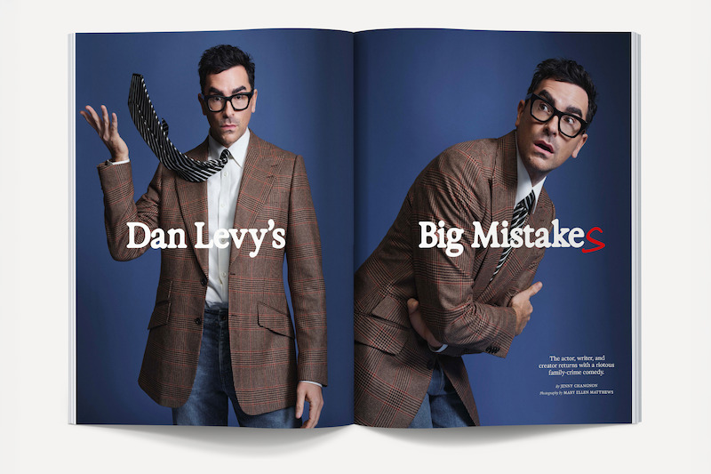 Man in brown plaid blazer and glasses poses in studio on magazine spread with blue background; left side shows him tossing a phone, right side features a contemplative pose. Text overlays read “Dan Levy’s Big MistakeS.”