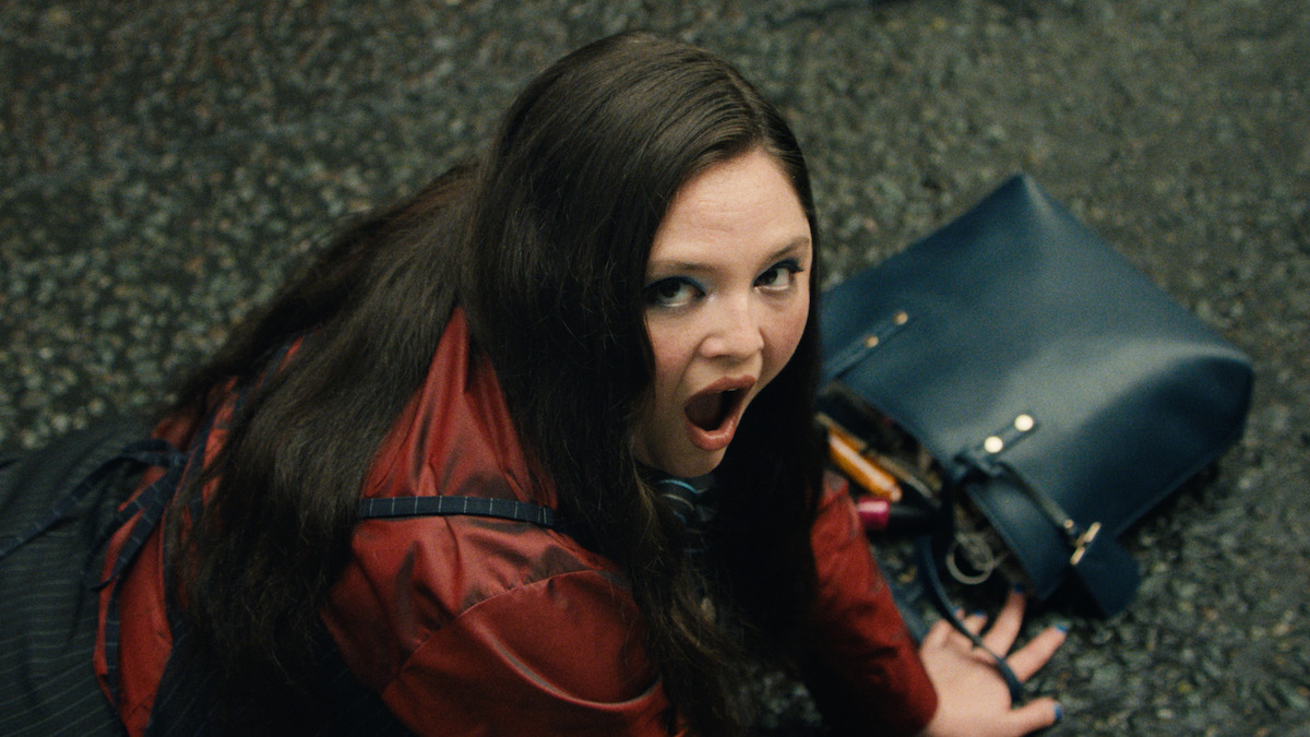 Meg Stalter as Jessica looking up in shock