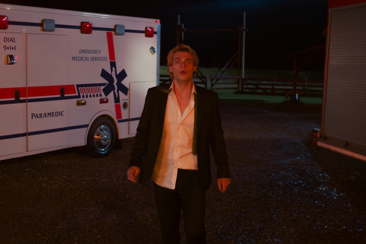 Noah LaLonde as Cole stands in front of an ambulance in ‘My Life with the Walter Boys’ Season 2.