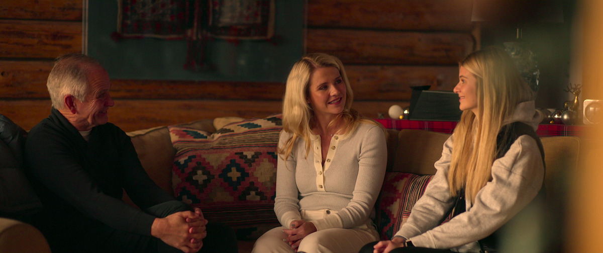 Ed Smart, Elizabeth Smart, and Mary Katherine Smart sit on the couch together.