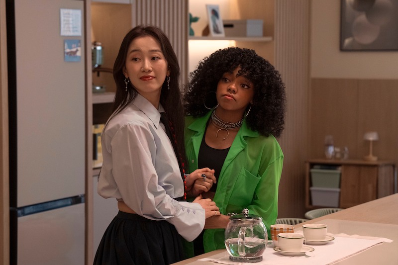 Gia Kim as Yuri Han and Regan Aliyah as Juliana Porter stand in a kitchen together in Season 2 of 'XO, Kitty'