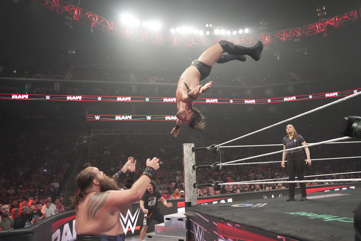 JD McDonagh jumps from the top rope out of the ring against Ivar.