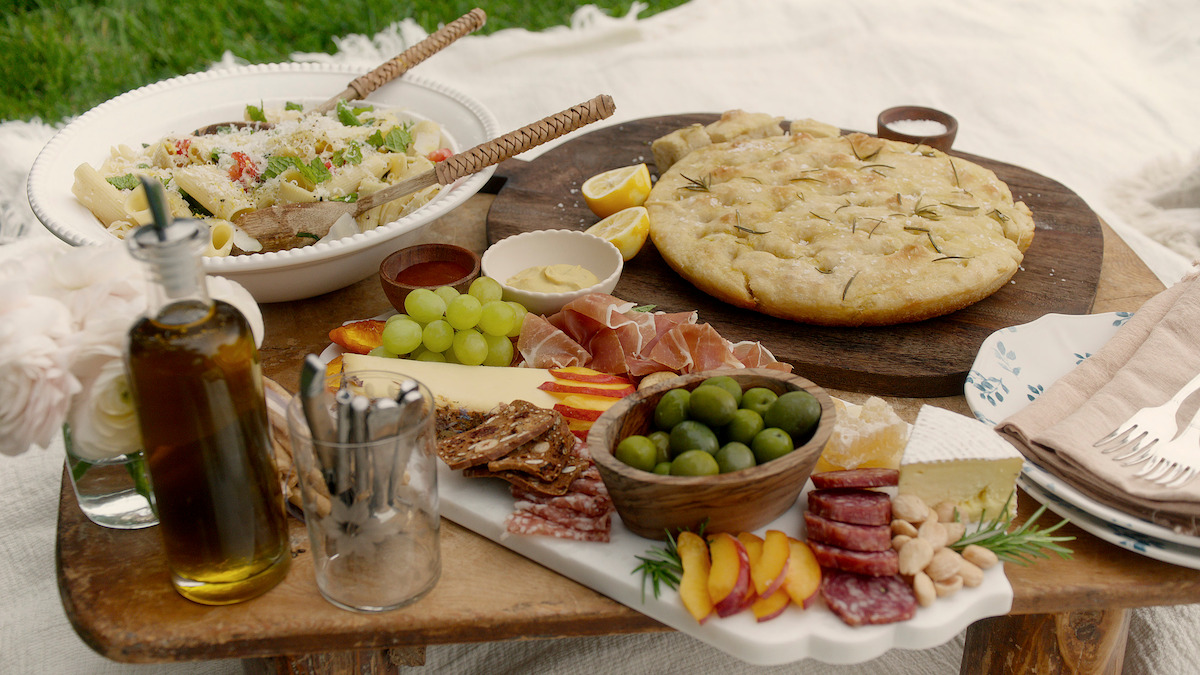 Focaccia placed next to a charcuterie board on a table.