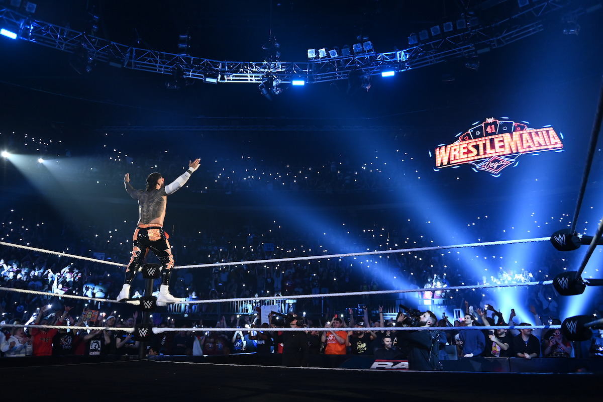Jey Uso stands on the ropes facing the Wrestlemania logo