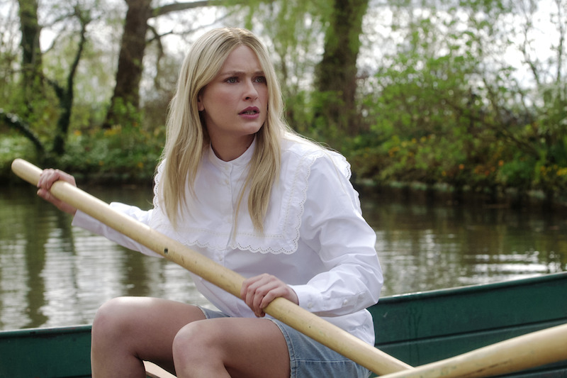 Camille Razat as Camille rows a boat in a pond in Season 4 of 'Emily in Paris'