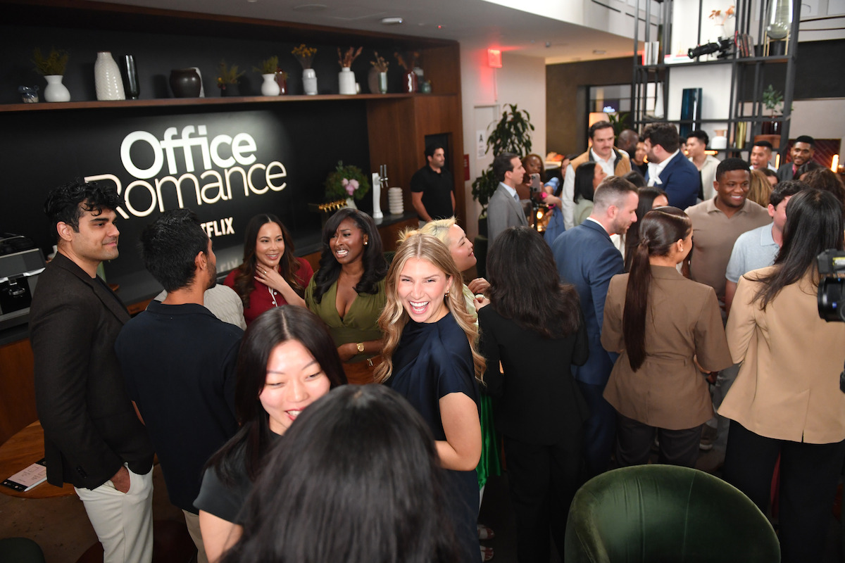 Crowd of people mix and mingle at speed dating event.