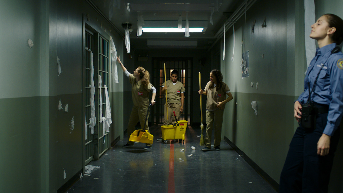 prisoners mop a hallway