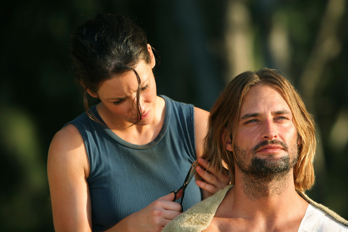 Evangeline Lilly giving Josh Holloway a haircut.