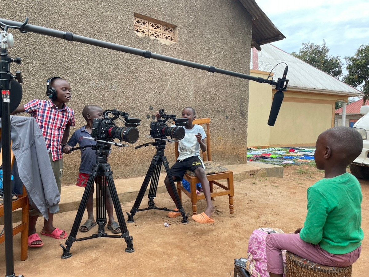 A group of kids playing with camera equipment.