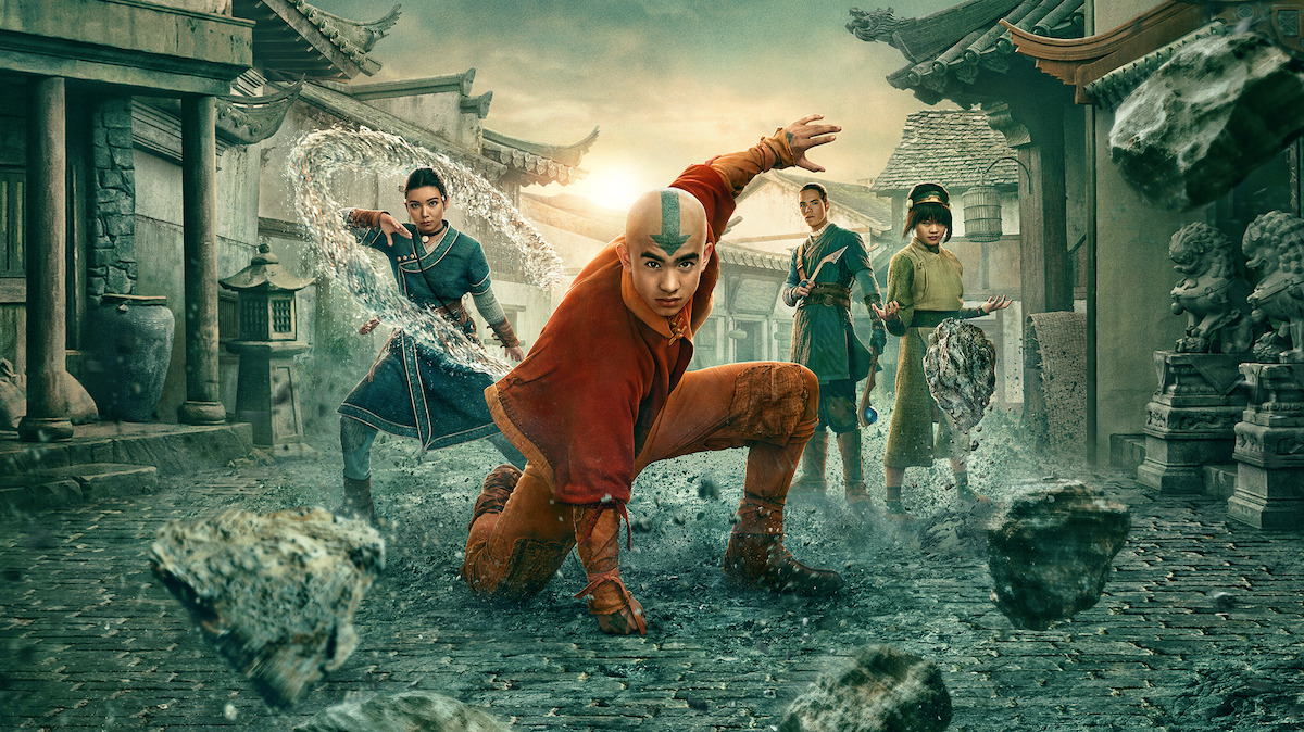 Four young warriors with elemental powers pose in a village setting, with one leading at the front controlling rocks, and the others behind using water, earth, and air bending abilities. The environment features ancient Asian-style buildings.