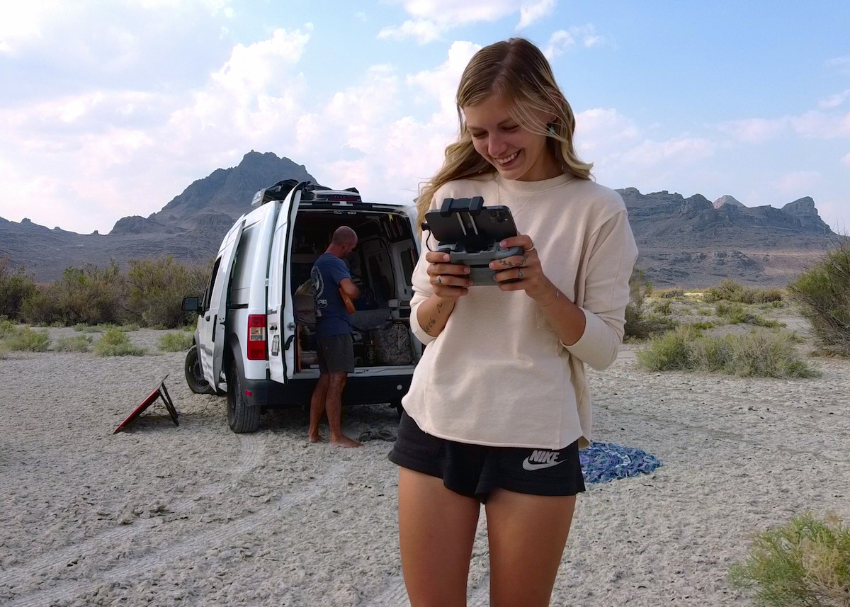 Gabby Petito looks at her camera in front of her van in a national park