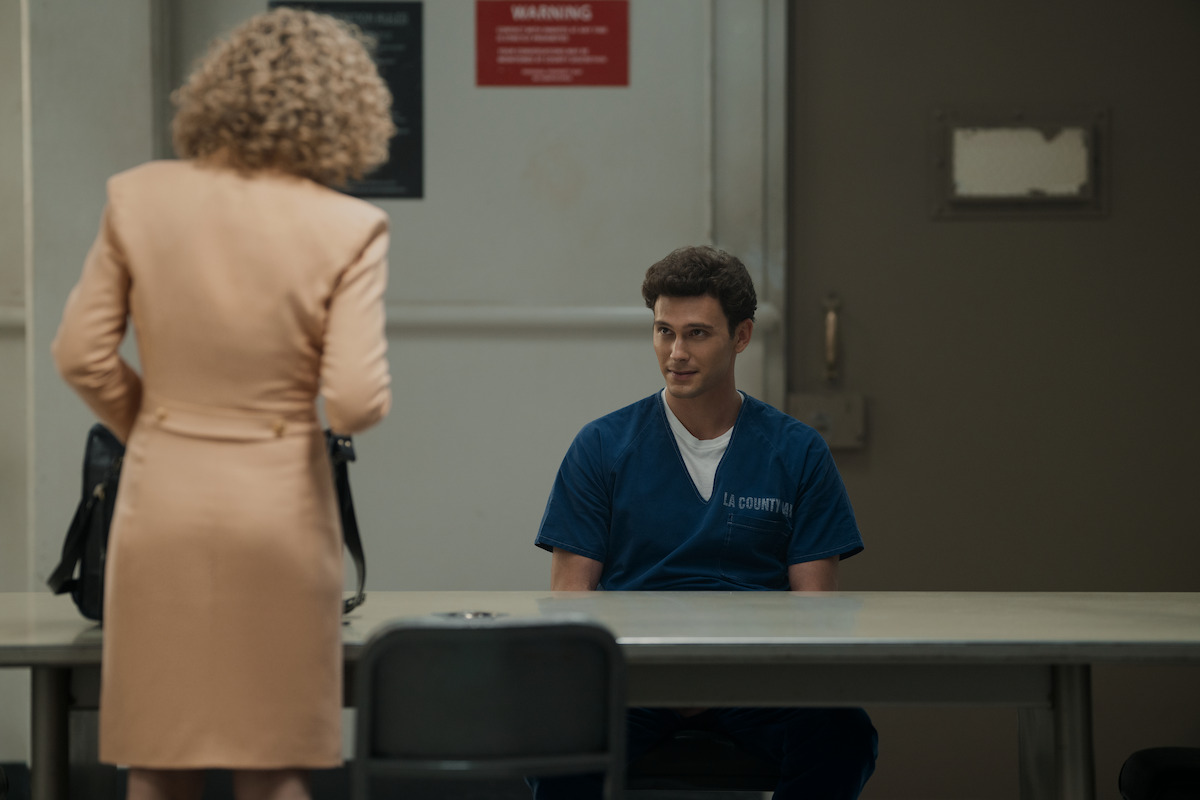 Leslie Abramson (Ari Graynor) talks to Erik Menendez (Cooper Koch) in an official looking room.