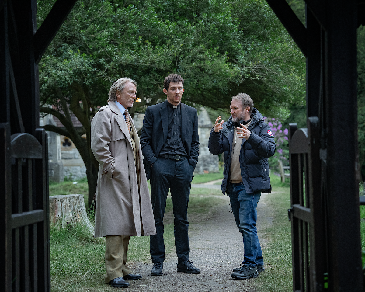 A behind the scenes shot of Daniel Craig and Josh O'Connor working with director Rian Johnson in 'Wake Up Dead Man'