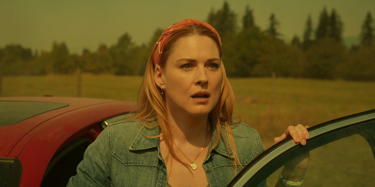 Alexandra Breckenridge as Mel Monroe stands exiting a car with a concerned expression in Season 5 of ‘Virgin River.’