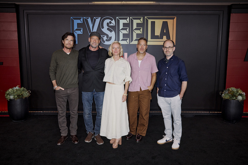 A group of five people pose.