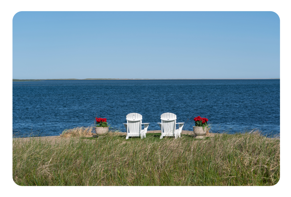 Two beach chairs look out over the water in 'The Perfect Couple'