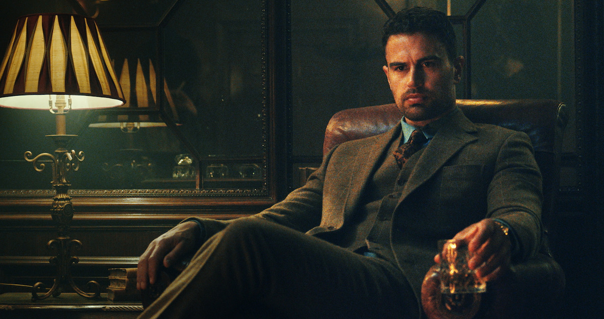 Theo James as Eddie Horniman sits in a leather chair in season 1 of 'The Gentlemen'
